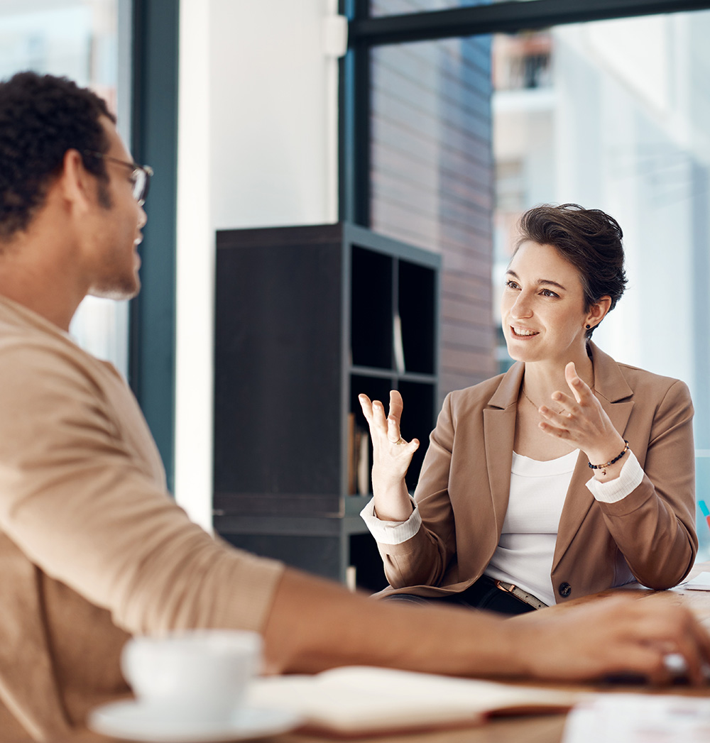 Mentor, Training And A Woman Manager With An Employee In The Office For Coaching On Company Vision. Management, Meeting And A Female Business Person Talking To A Professional Male Colleague At Work